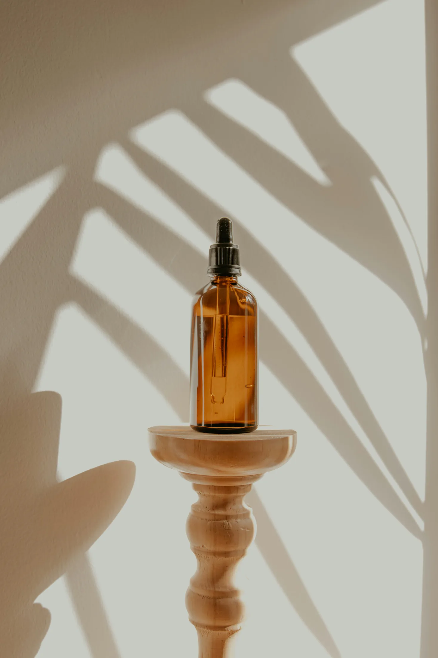 An amber bottle of aromatic oil in natural light
