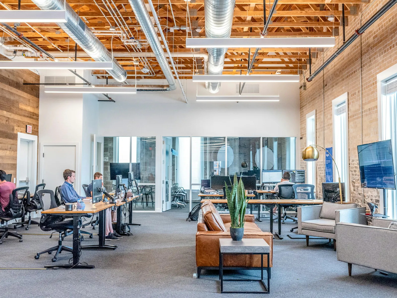 A modern team workspace with employees at their desks